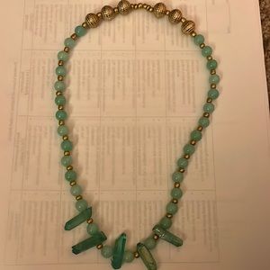 A jade necklace with crystals and gold beads.
